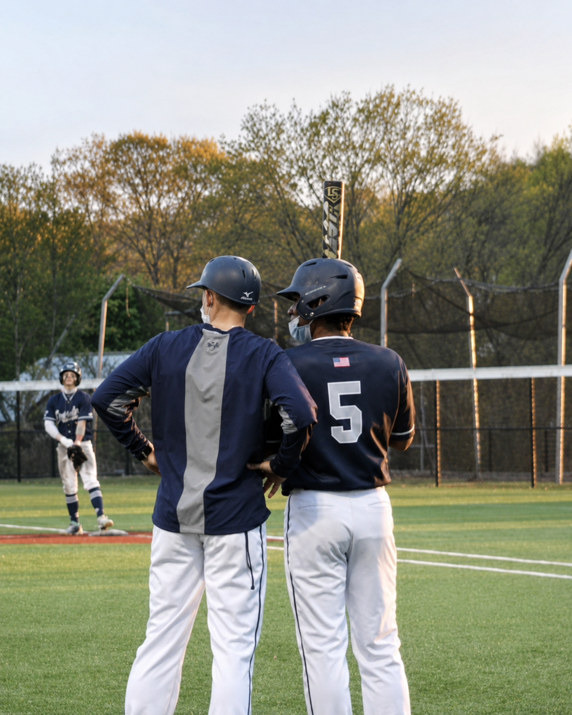 Coach coaching first base during a game