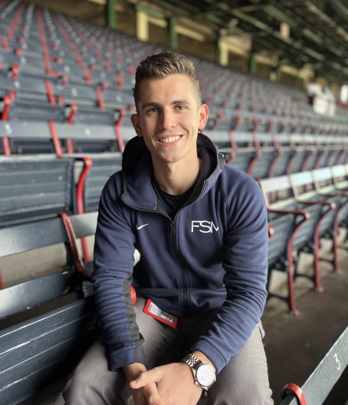 Jonathan Liskov, founder of Clutch Guard, seated in a ballpark grandstand